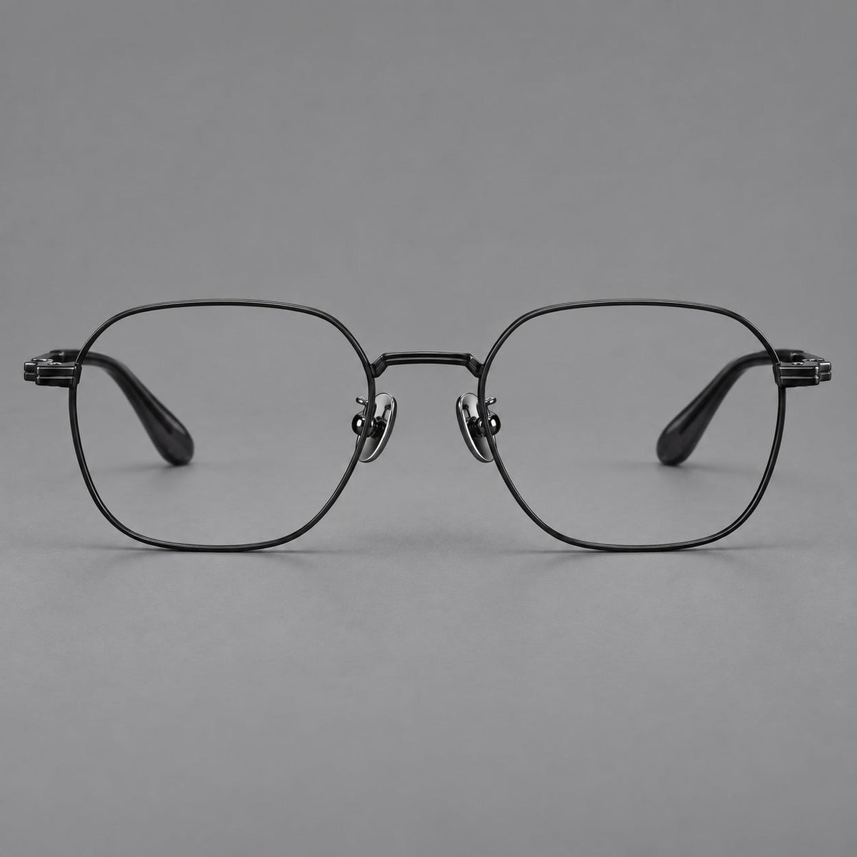 Soft square titanium glasses with an angular bridge and layered corner details in Black, front view
