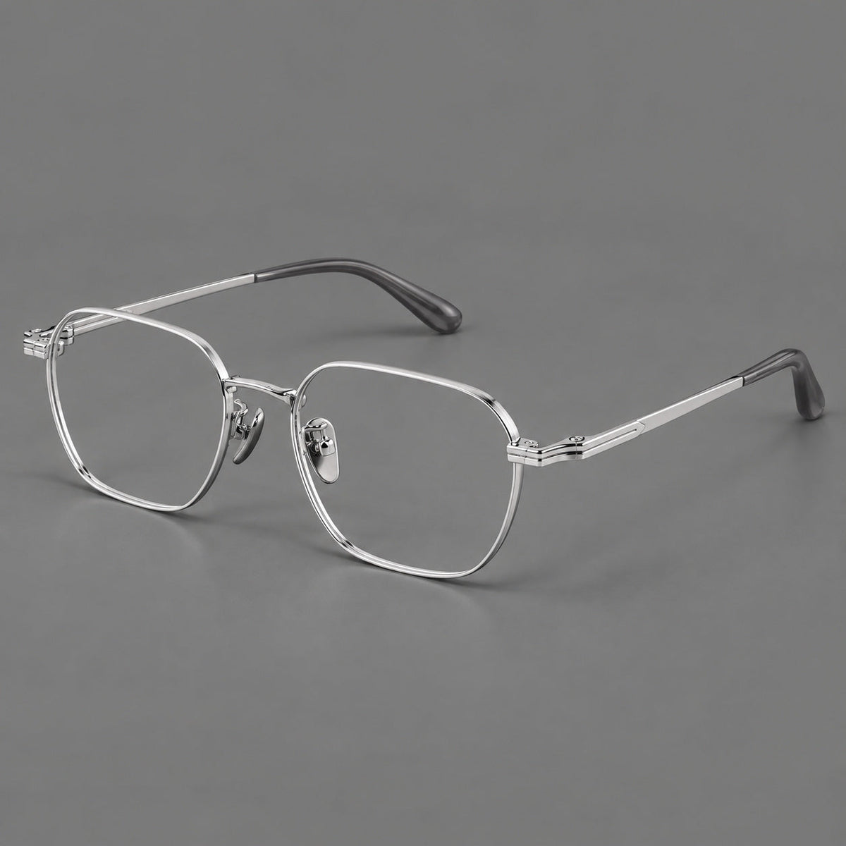 Soft square titanium glasses with an angular bridge and layered corner details in Silver, three quarter view