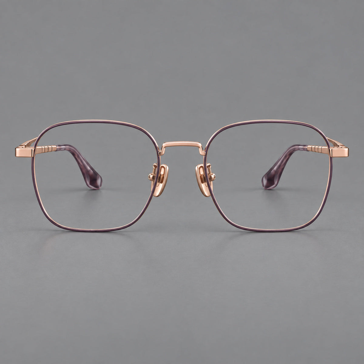 Soft square titanium glasses with a raised bridge and engraved temple bands in Purple and Rose Gold, front view