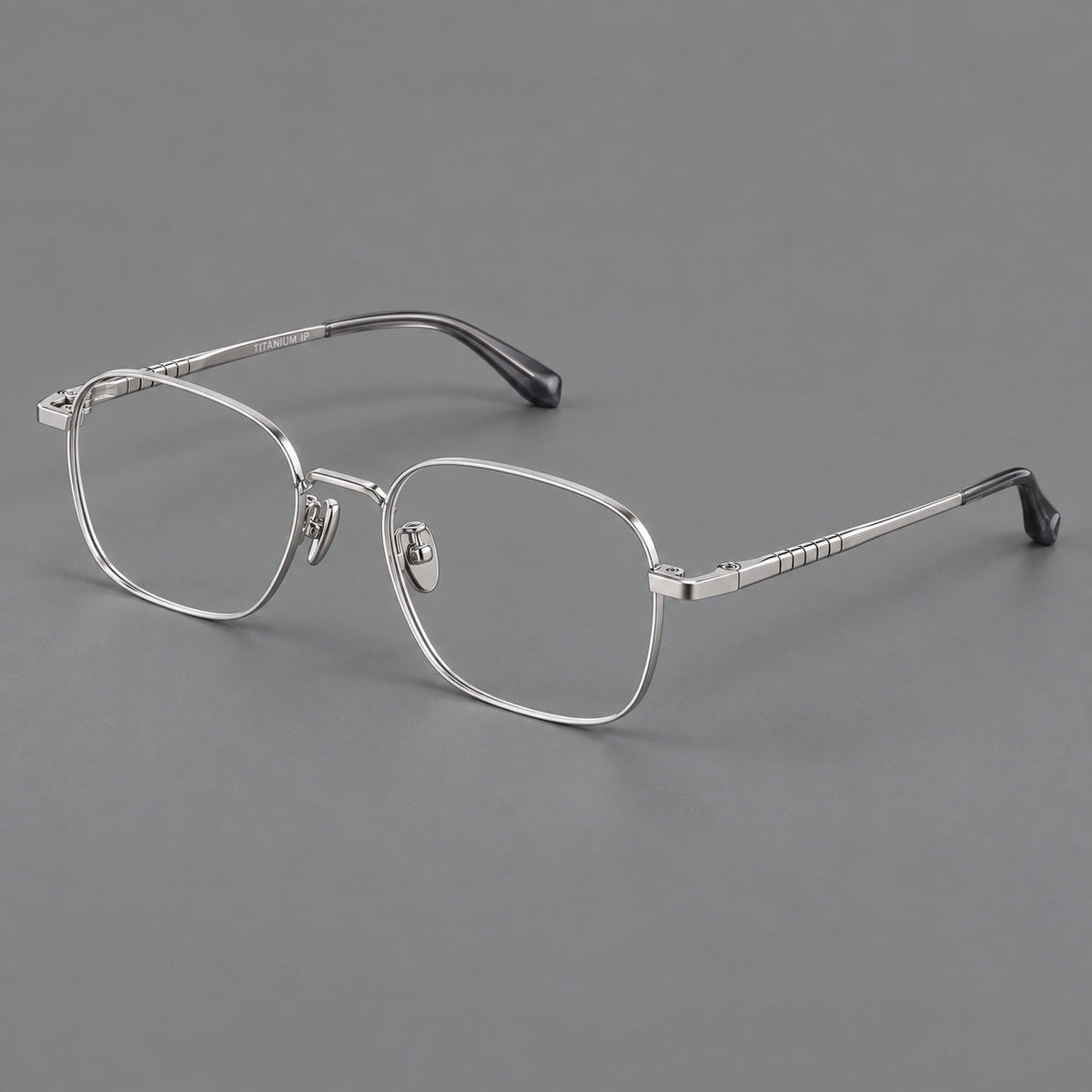 Soft square titanium glasses with a raised bridge and engraved temple bands in Silver, three quarter view