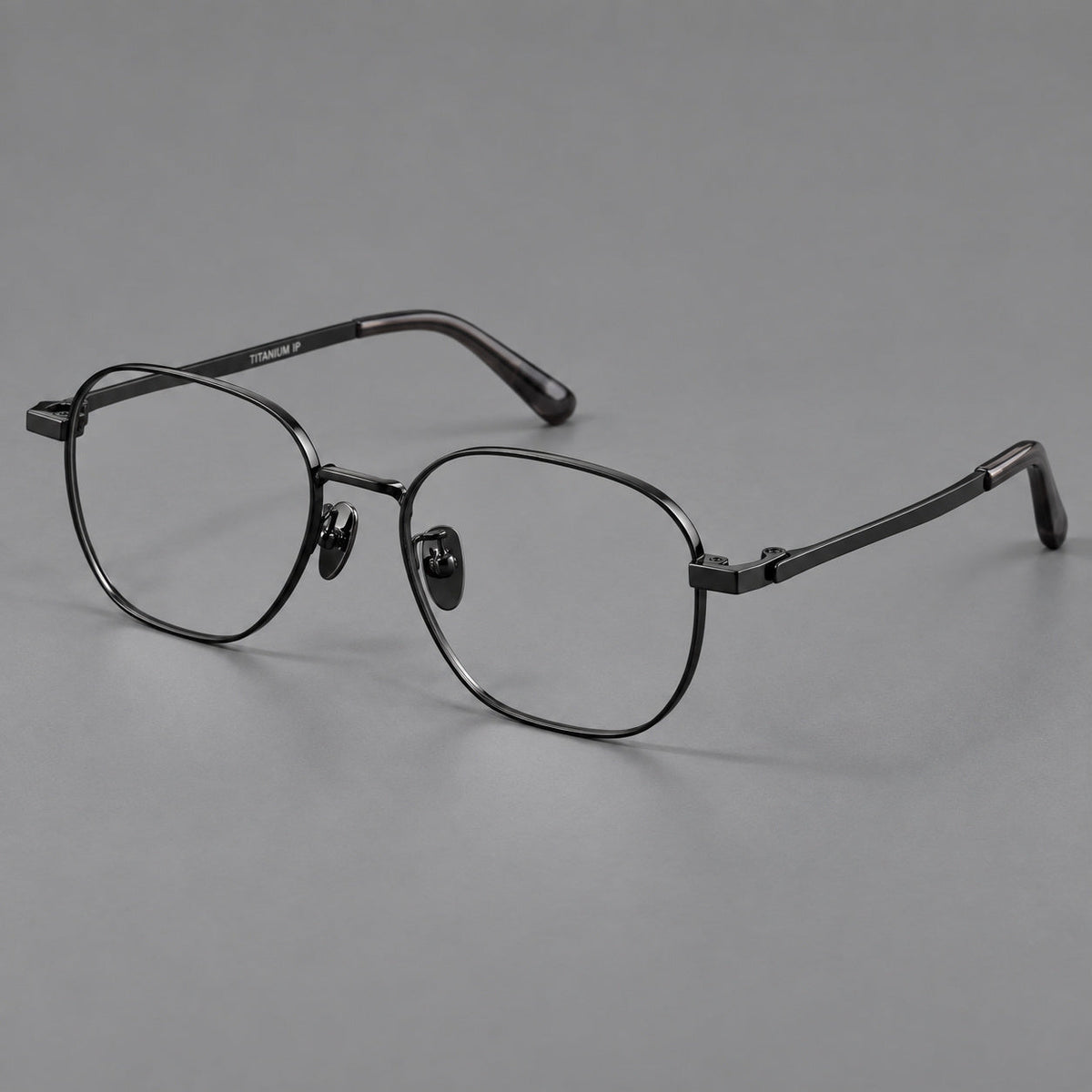 Rounded panto titanium glasses with an angular bridge and broad flat temples in Black, three quarter view