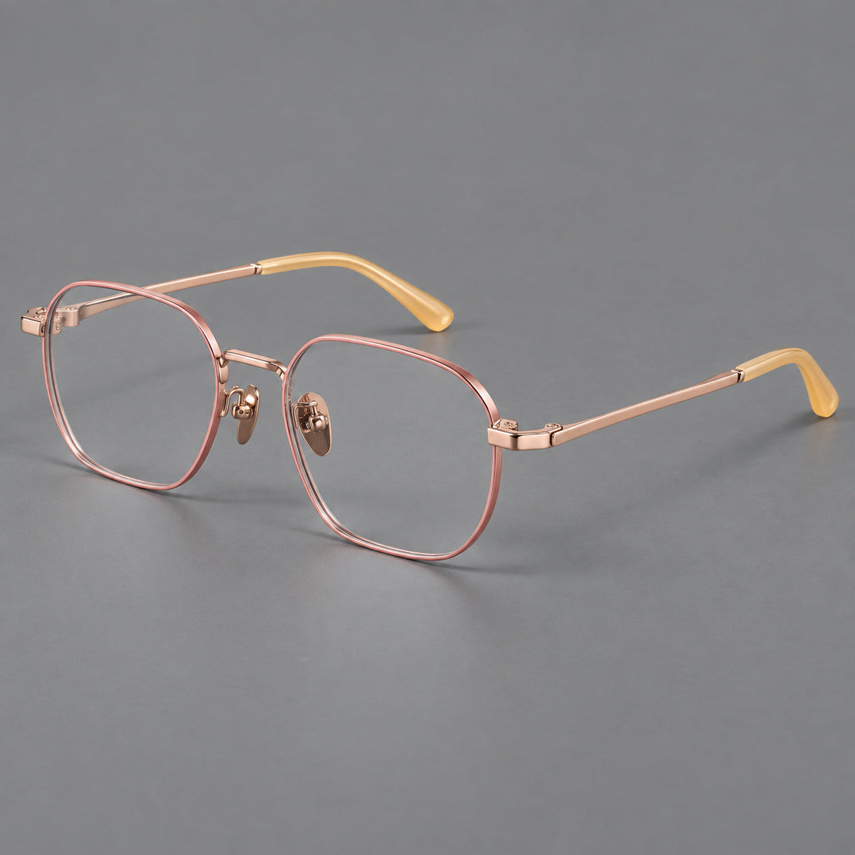 Rounded panto titanium glasses with an angular bridge and broad flat temples in Pink and Rose Gold, three quarter view