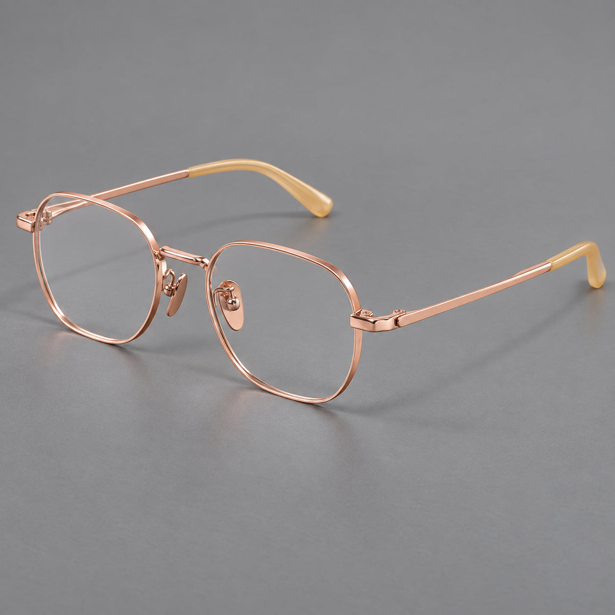 Rounded panto titanium glasses with an angular bridge and broad flat temples in Rose Gold, three quarter view