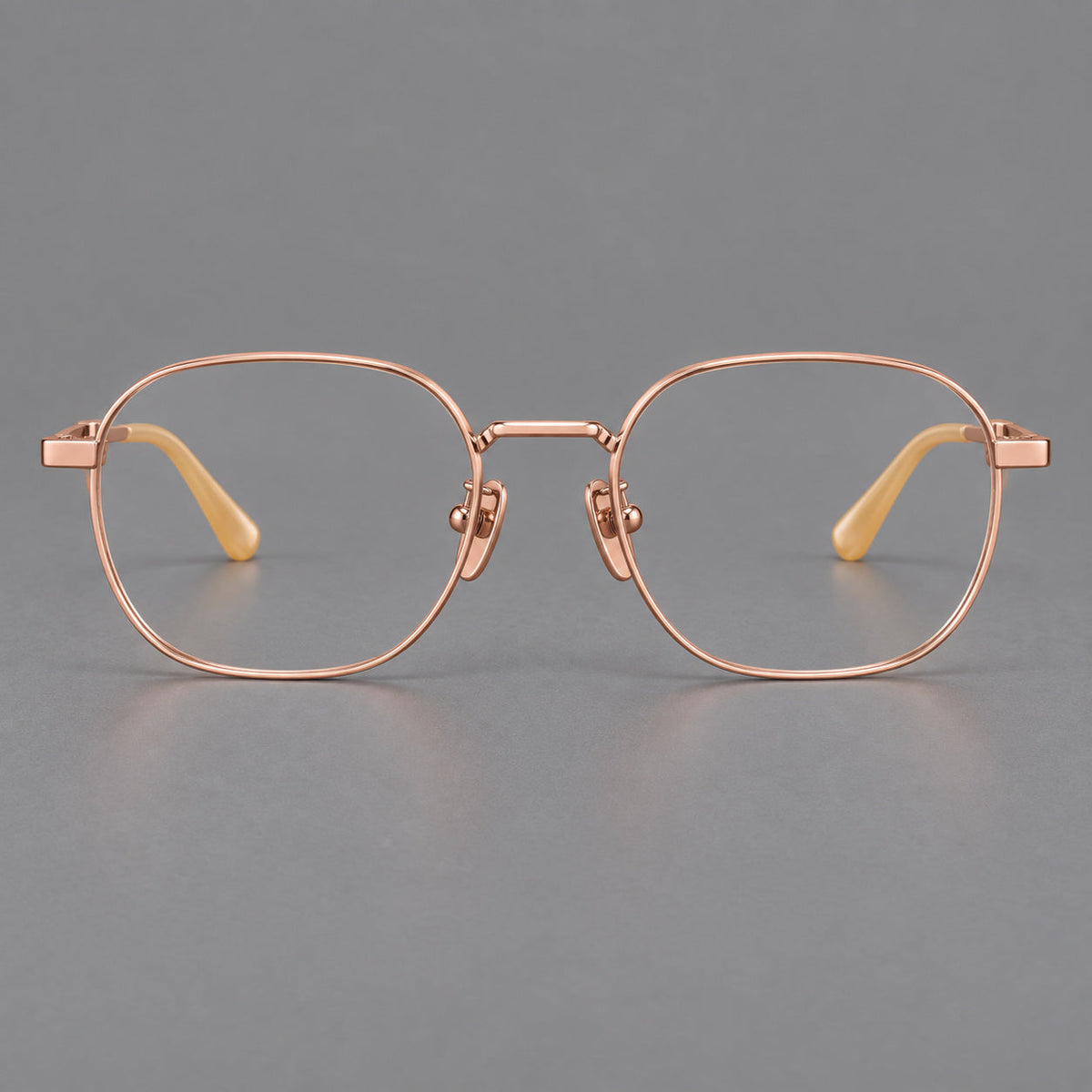 Rounded panto titanium glasses with an angular bridge and broad flat temples in Rose Gold, front view