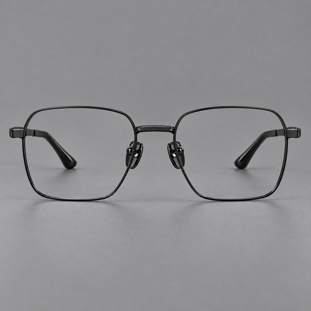 Geometric square titanium glasses with a textured bridge and fine temple grooves in Black, front view