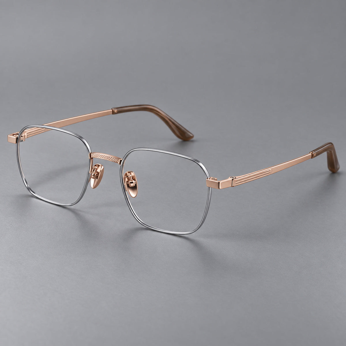 Geometric square titanium glasses with a textured bridge and fine temple grooves in Gray and Rose Gold, three quarter view