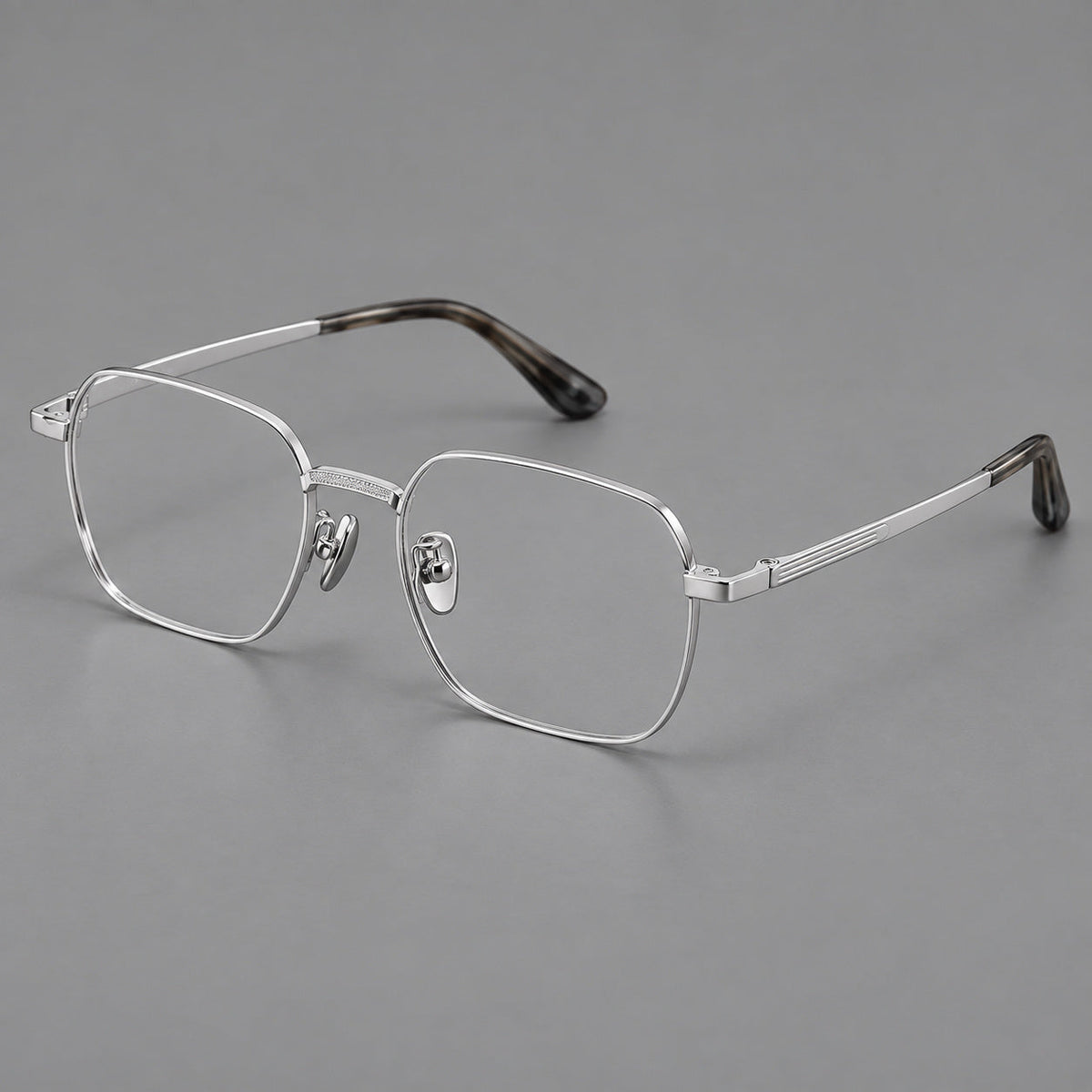 Geometric square titanium glasses with a textured bridge and fine temple grooves in Silver, three quarter view
