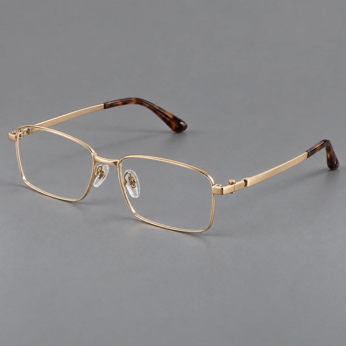 Wide rectangular titanium glasses with a broad bridge and rounded hinge caps in Gold, three quarter view