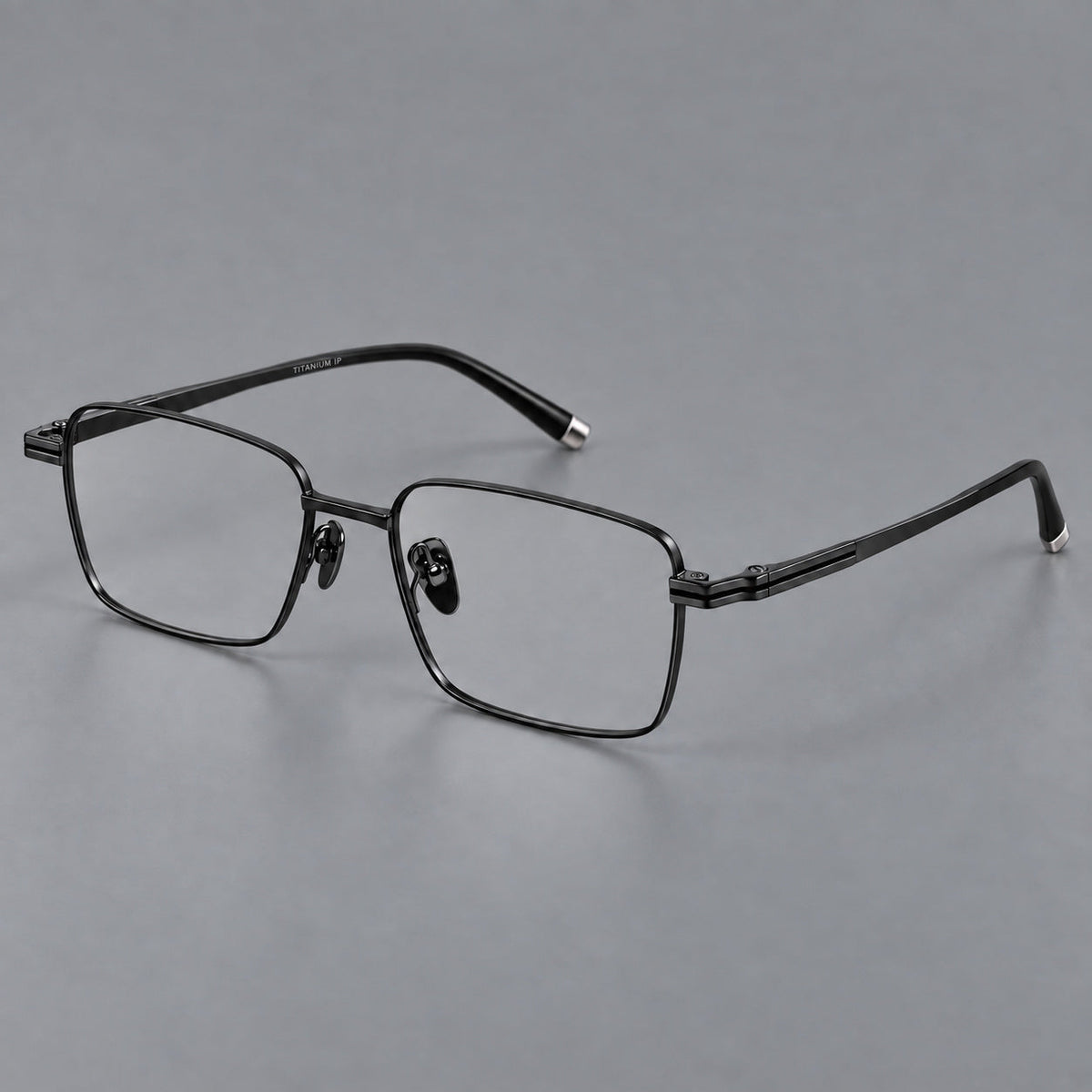 Rectangular titanium glasses with inset corner lines and metal capped temple tips in Black, three quarter view