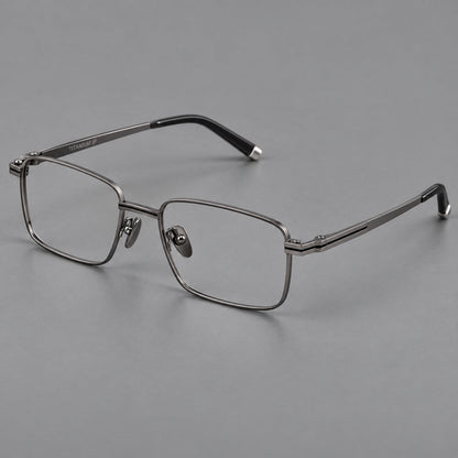 Rectangular titanium glasses with inset corner lines and metal capped temple tips in Gunmetal, three quarter view front view