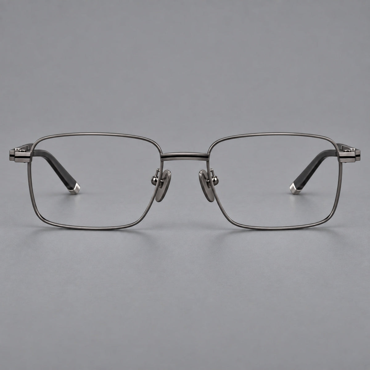 Rectangular titanium glasses with inset corner lines and metal capped temple tips in Gunmetal, front view