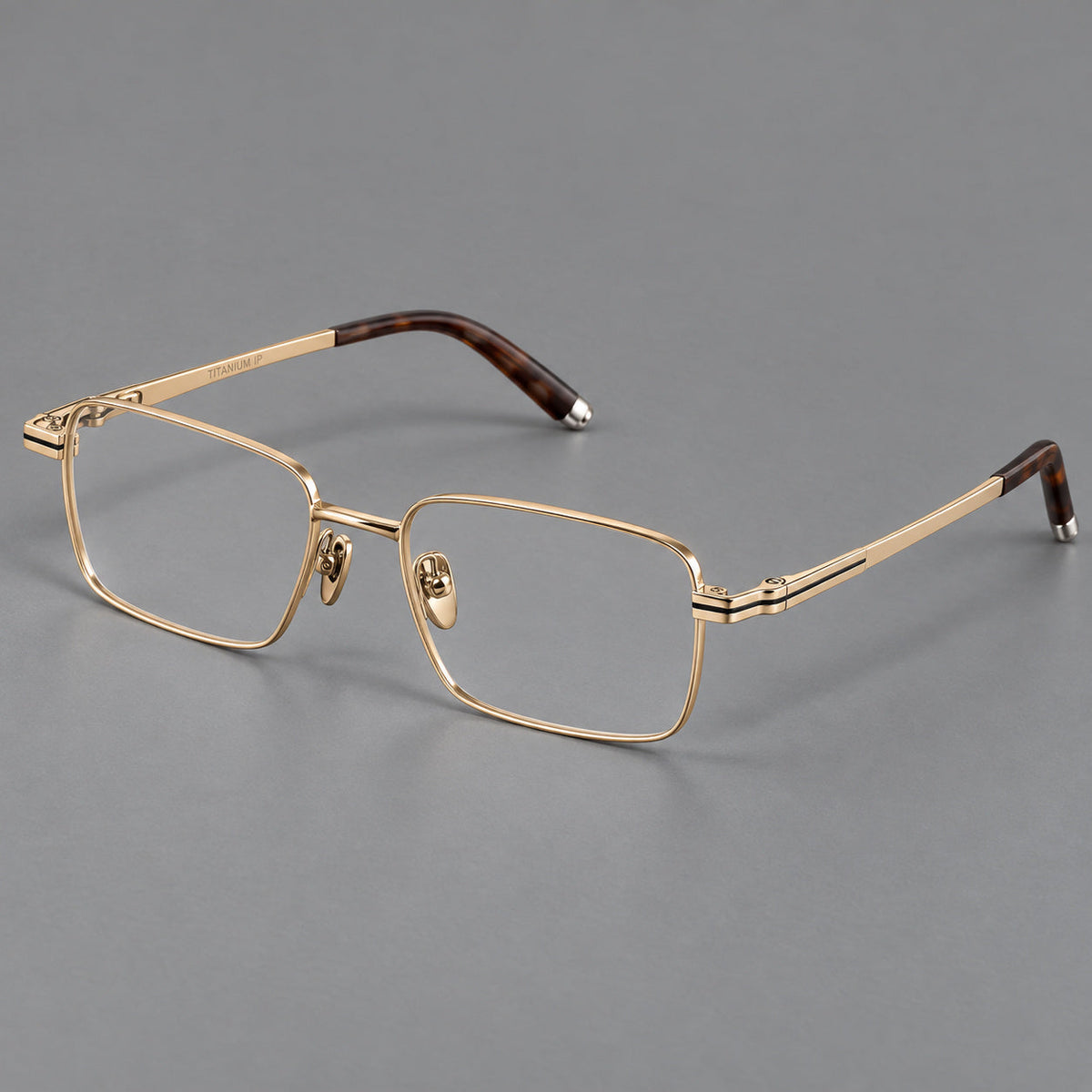 Rectangular titanium glasses with inset corner lines and metal capped temple tips in Gold, three quarter view