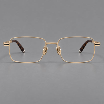 Rectangular titanium glasses with inset corner lines and metal capped temple tips in Gold, front view temple detail