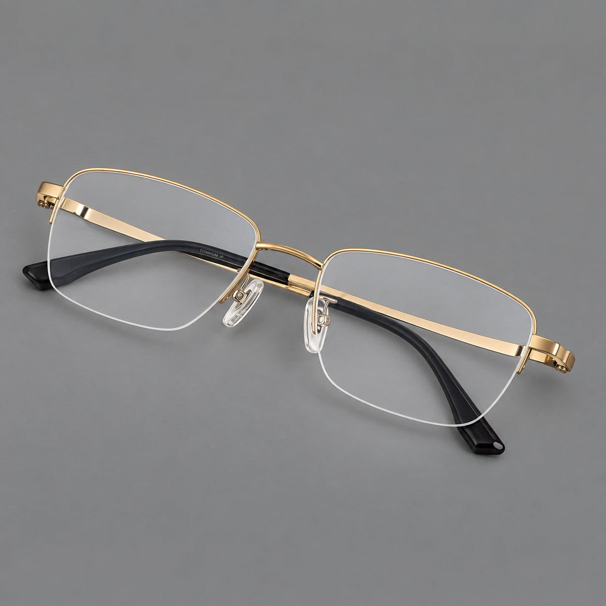 Half frame titanium glasses with rectangular lenses and rounded hinge details in Gold, three quarter view