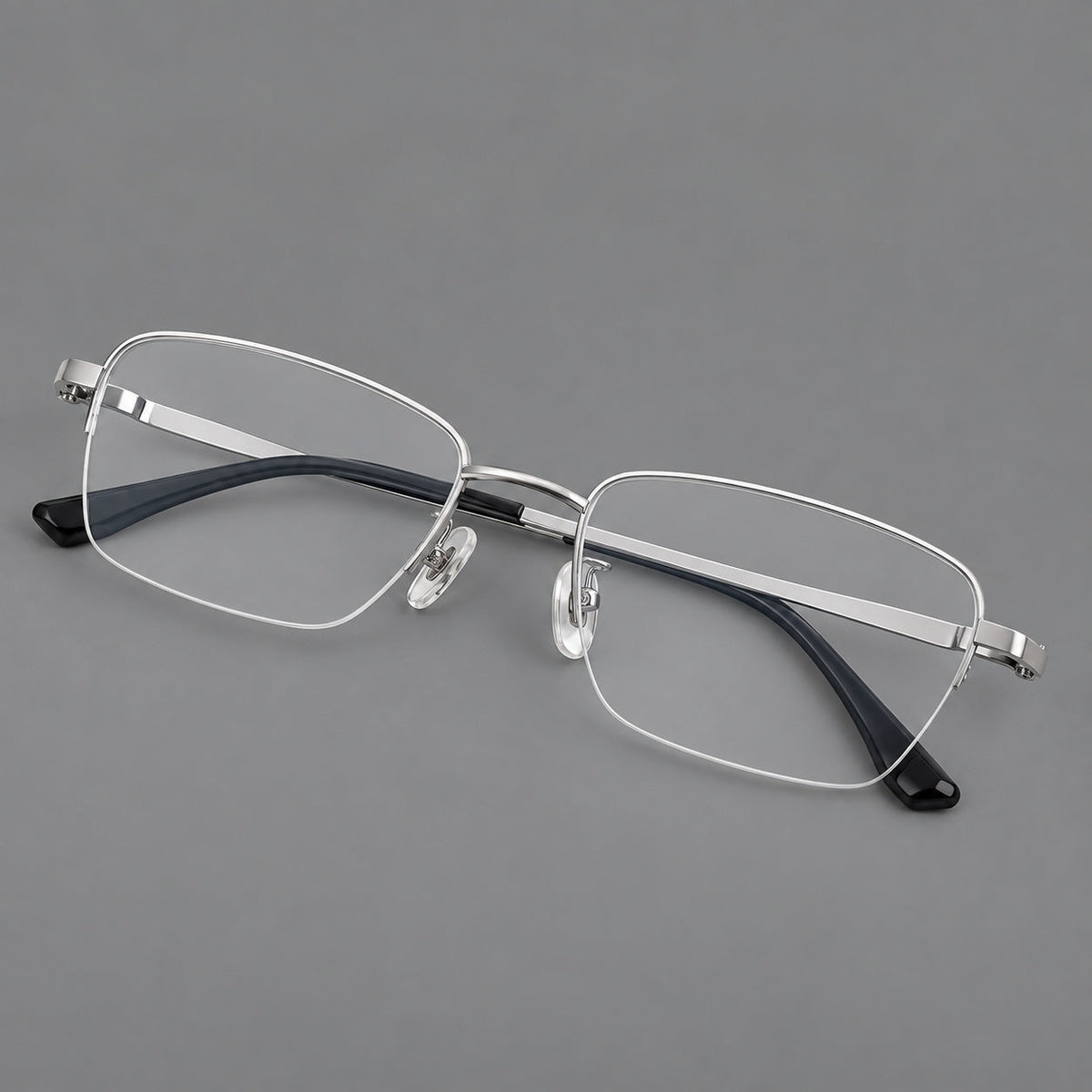 Half frame titanium glasses with rectangular lenses and rounded hinge details in Silver, three quarter view
