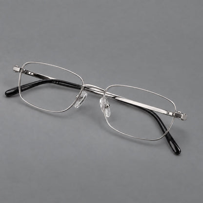 Shallow rectangular titanium glasses with a broad bridge and stepped temple joins in Silver, three quarter view additional product view