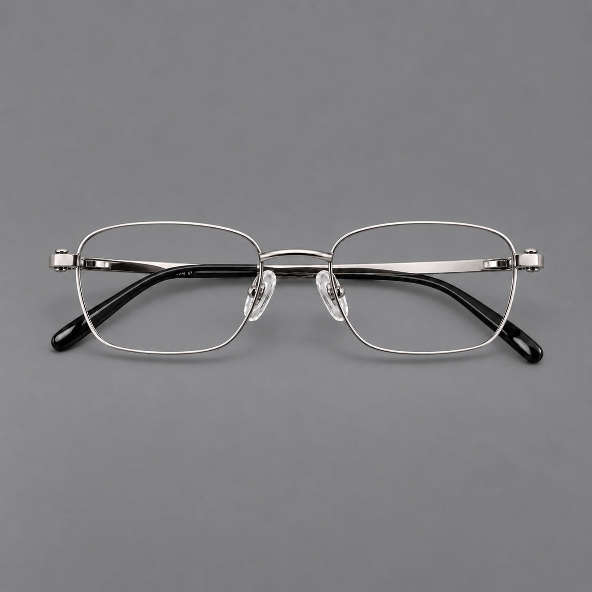 Shallow rectangular titanium glasses with a broad bridge and stepped temple joins in Silver, front view